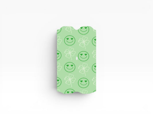 Cloud Skinz green vape wrap featuring a playful pattern of heart-eyed smiley faces and white four-leaf clovers.