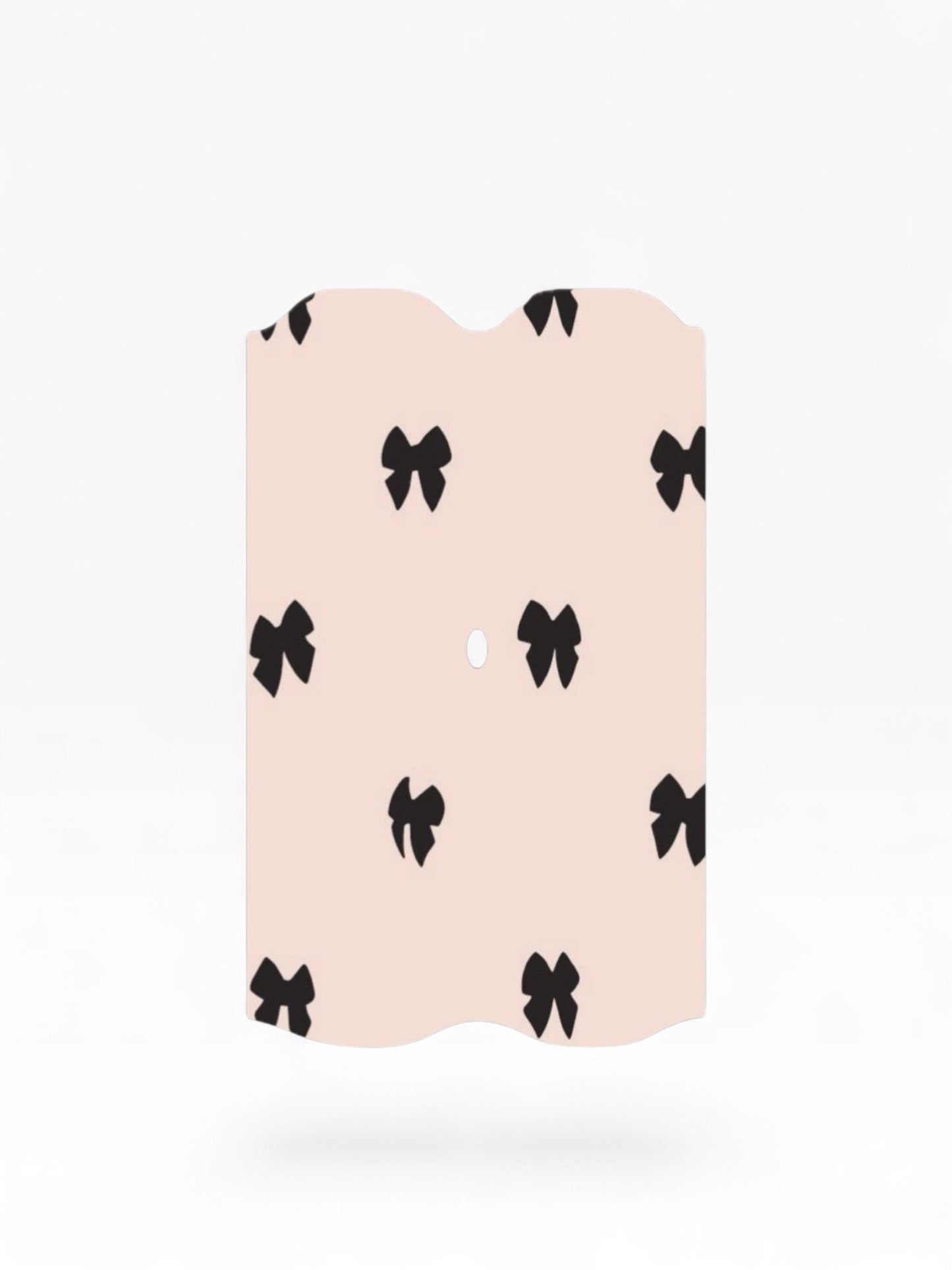 Cloud Skinz waterproof Vuse Alto decal featuring a light pink background with a black bow pattern.