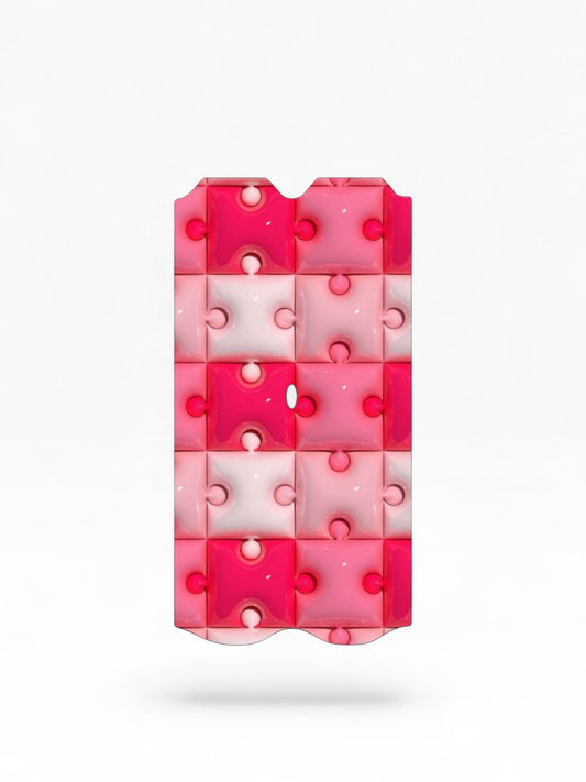 Cloud Skinz waterproof Vuse Alto decal featuring a glossy pink and white puzzle piece pattern.