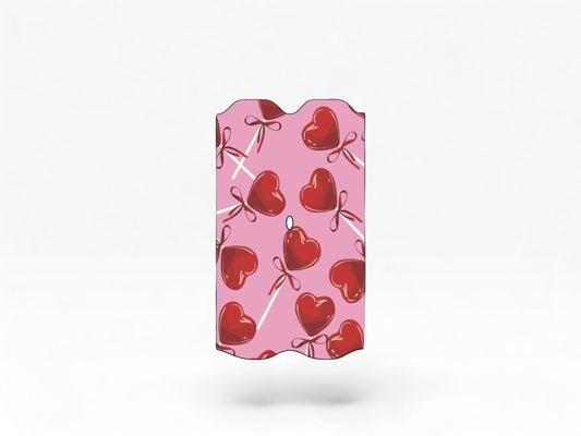 Cloud Skinz waterproof Vuse Alto decal featuring a pink background with red heart lollipop patterns.